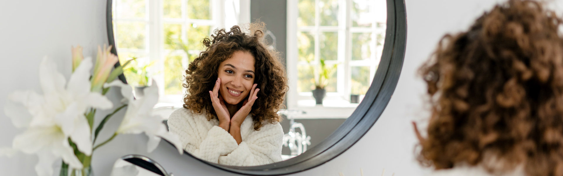 woman looking at herself in the mirror