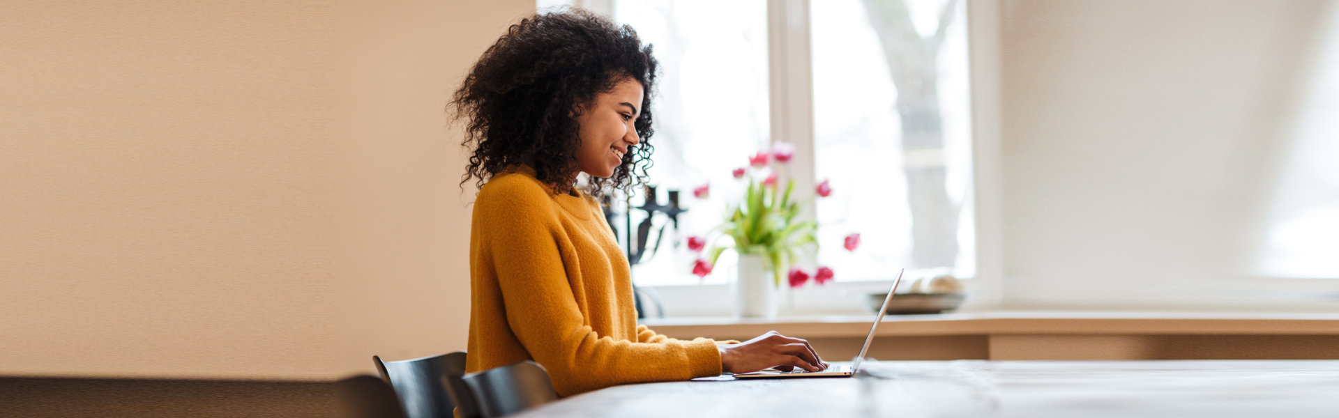 woman using laptop while sitting at table